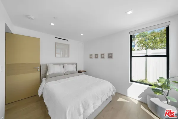 a view of a porch with a table and chairs and potted plants
