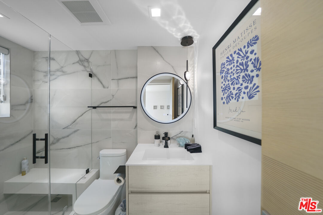 1500 Ocean Drive Oxnard, CA 93035 - Photo 18 of 75 a bathroom with a toilet sink and mirror