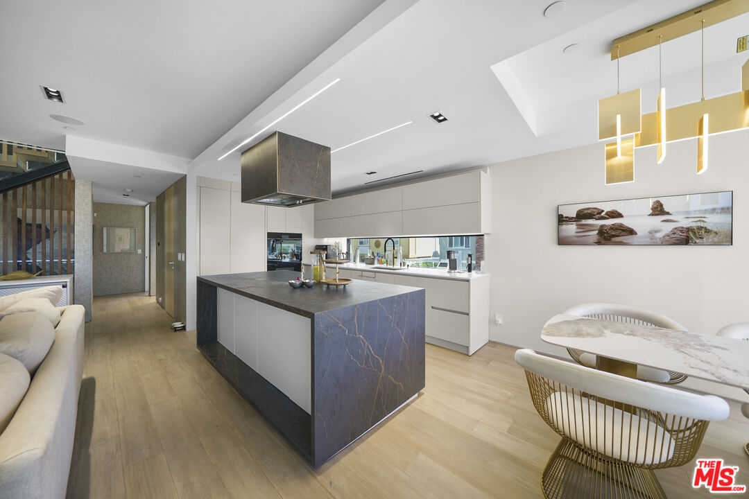 1500 Ocean Drive Oxnard, CA 93035 - Photo 29 of 75 a kitchen with stainless steel appliances kitchen island granite countertop a sink and cabinets