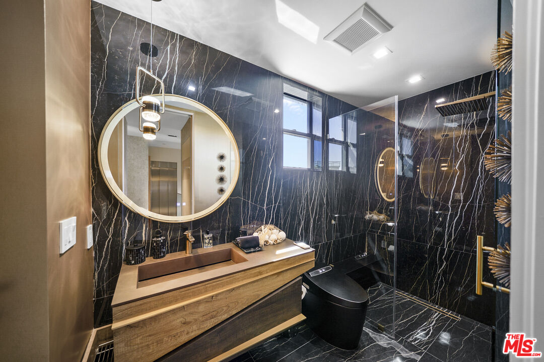 1500 Ocean Drive Oxnard, CA 93035 - Photo 37 of 75 a bathroom with a toilet a sink and a mirror