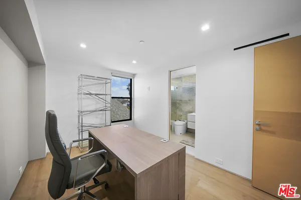 a view of a hallway with wooden shelves