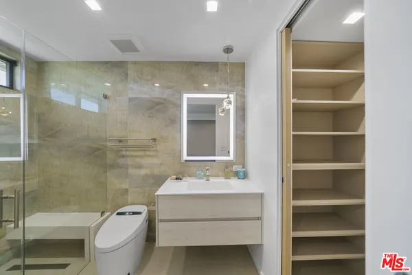 a view of a storage & utility room with two washing machine