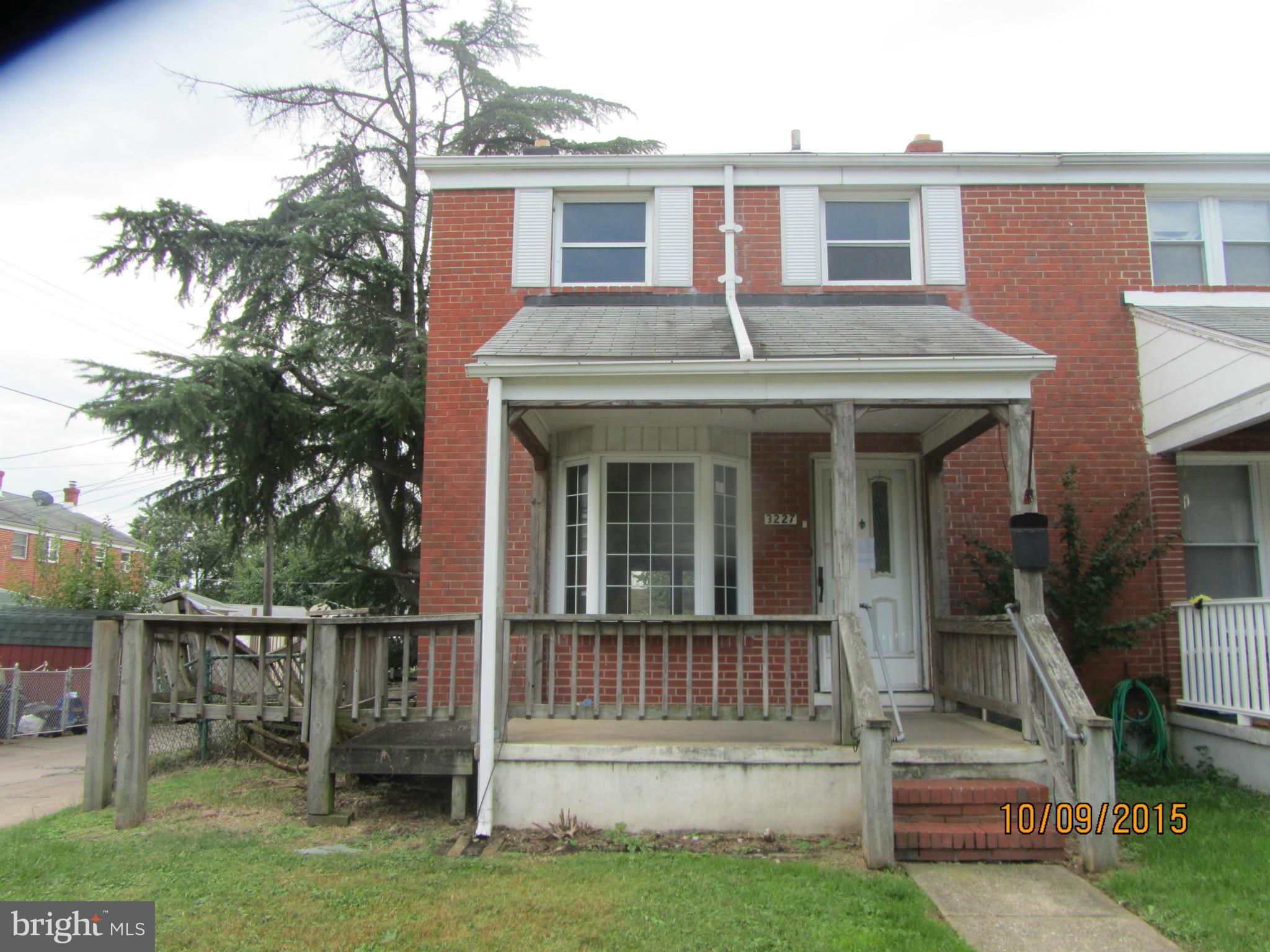 3227 Vulcan Road Baltimore, MD 21222 - Photo 1 of 17 a view of a house with a small yard and a large tree with wooden fence
