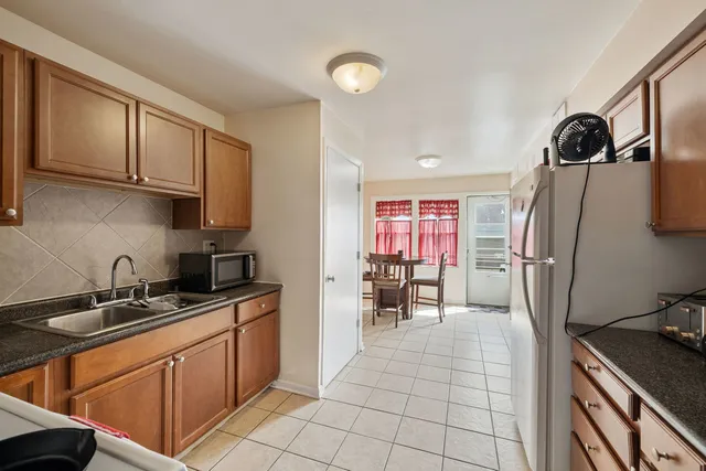 a kitchen with stainless steel appliances a sink stove refrigerator and cabinets