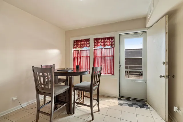 a view of a dining room with furniture and window