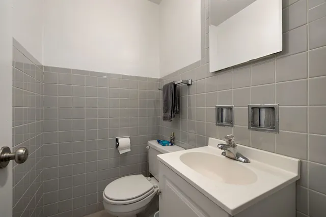a bathroom with a sink a toilet and mirror