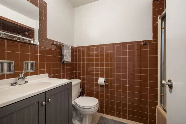 a bathroom with a sink toilet and mirror