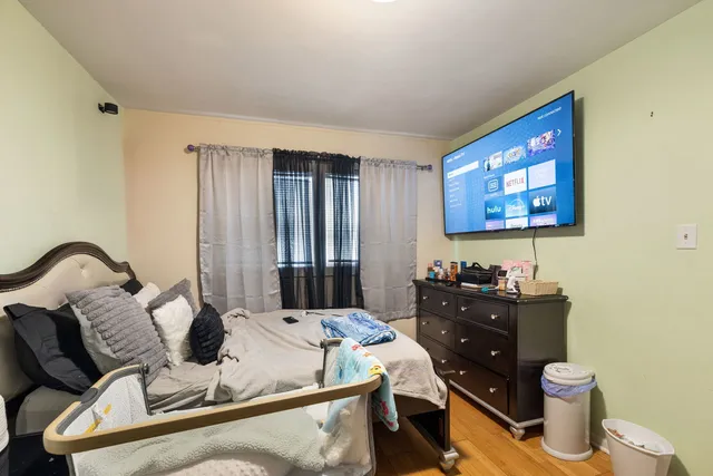 a bedroom with furniture and a wooden floor