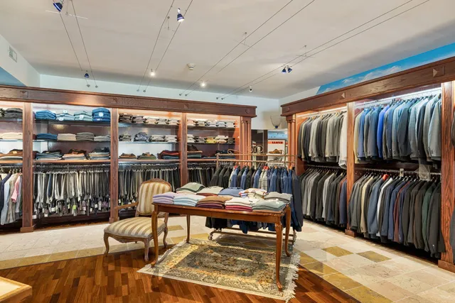 a living room with patio furniture and a floor to ceiling window