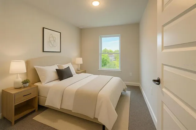 a bedroom with a bed and a window