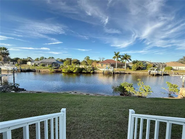 a view of a lake with houses in the back