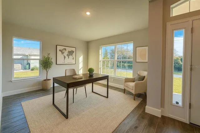 a living room with furniture a rug and a window