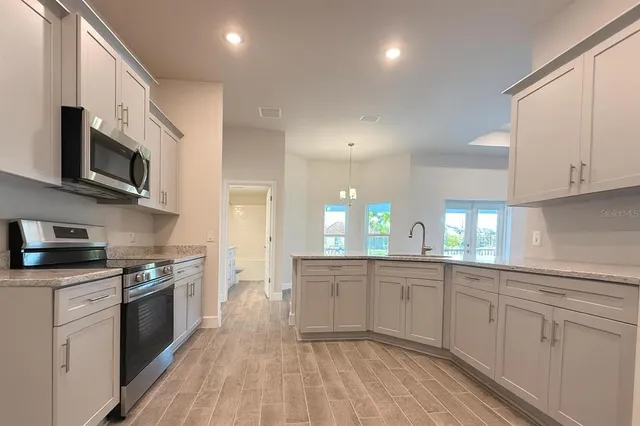 a kitchen with stainless steel appliances granite countertop a sink and cabinets
