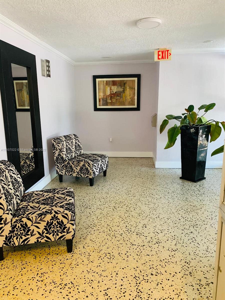 8001 Crespi Boulevard, Unit 2D Miami Beach, FL 33141 - Photo 3 of 12 a living room with a couch and a potted plant