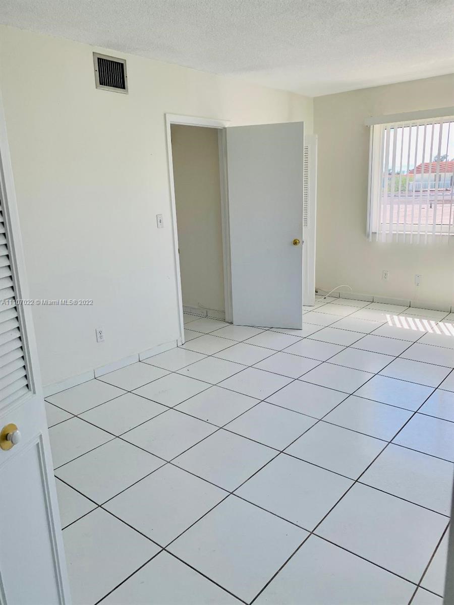 8001 Crespi Boulevard, Unit 2D Miami Beach, FL 33141 - Photo 9 of 12 a view of an empty room and window