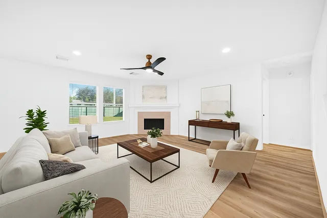 a living room with furniture fireplace and a table