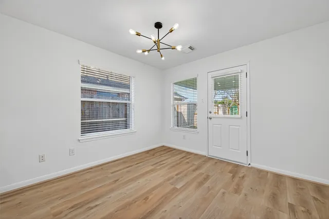 wooden floor in an empty room with a window