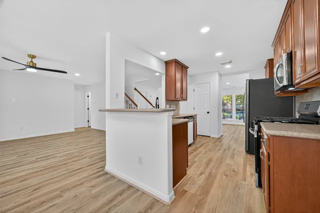 a view of a kitchen with furniture and wooden floor