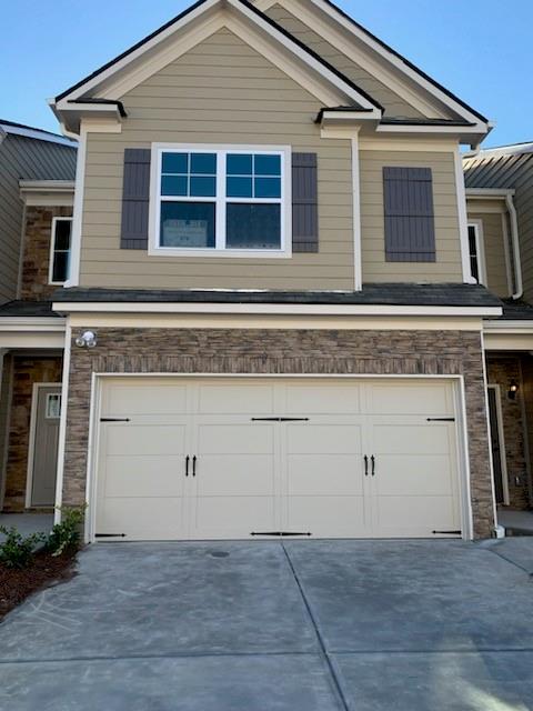 7690 Baron Road, Unit 606 Fairburn, GA 30213 - Photo 1 of 1 a view of a house with garage