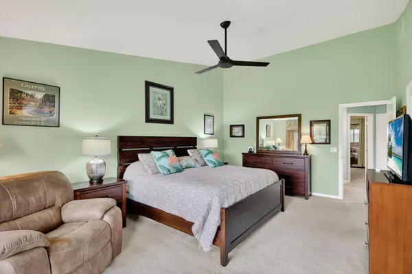 a bedroom with a bed and a large mirror