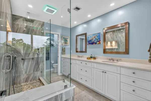 a bathroom with a double vanity sink and mirror