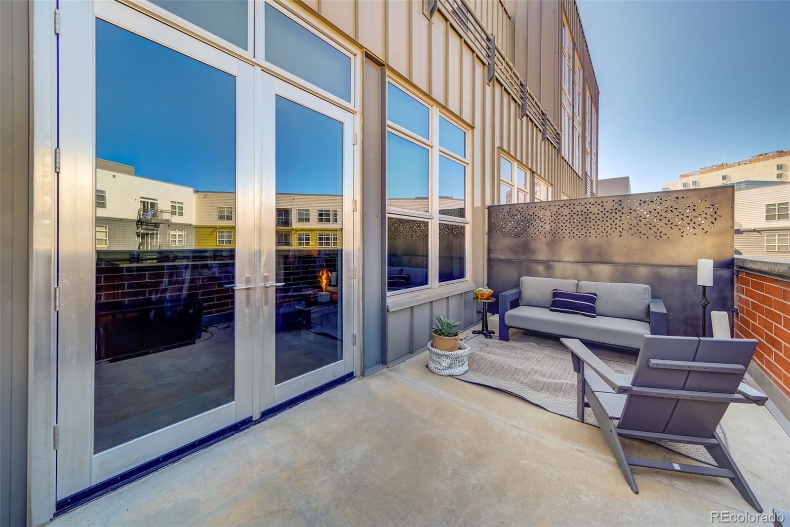 2955 Inca Street, Unit 3K Denver, CO 80202 - Photo 17 of 33 a backyard of a house with sofas table and chairs