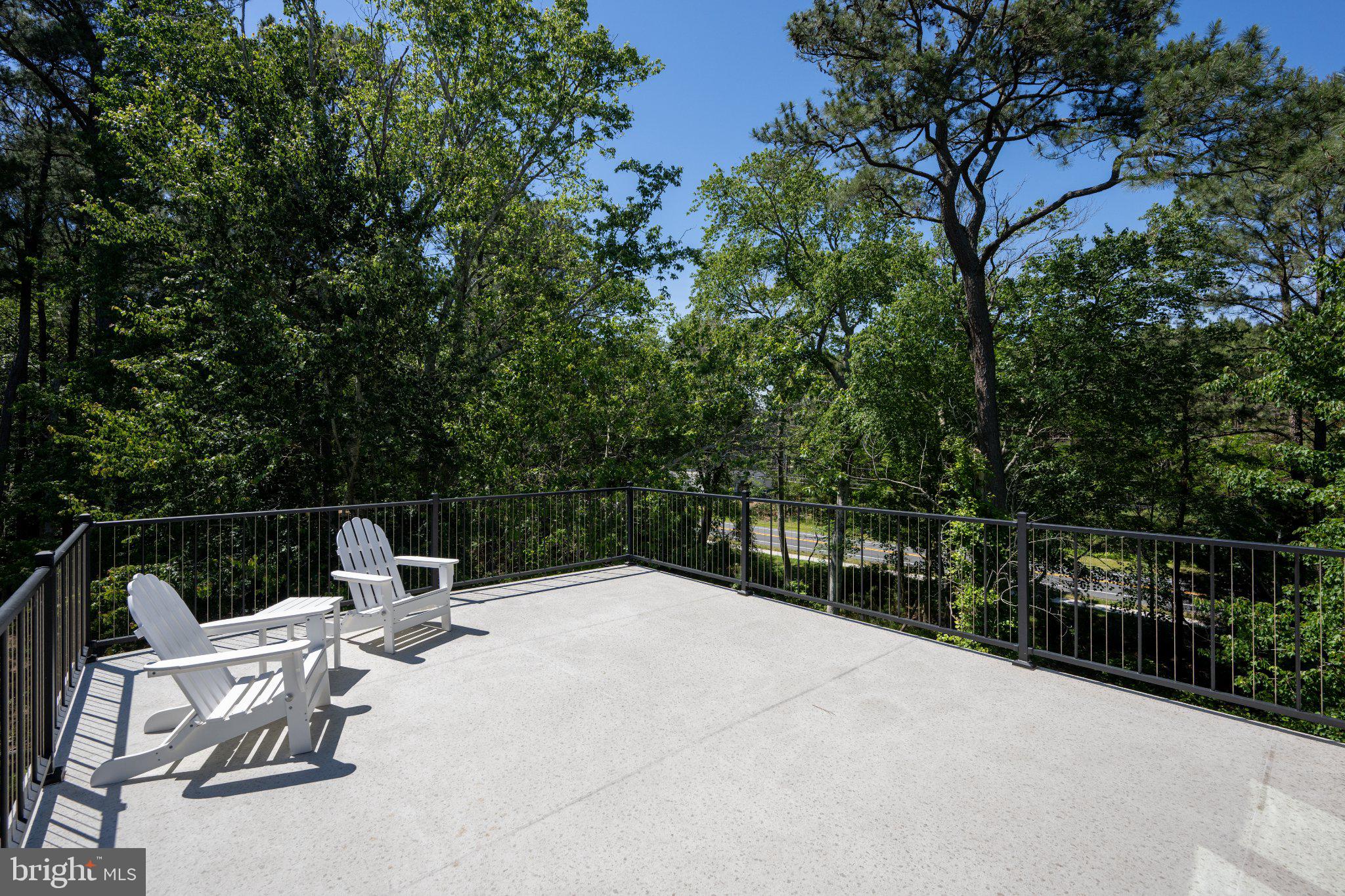 402 Salt Pond Road Bethany Beach, DE 19930 - Photo 40 of 55 Serene deck with lush green views.