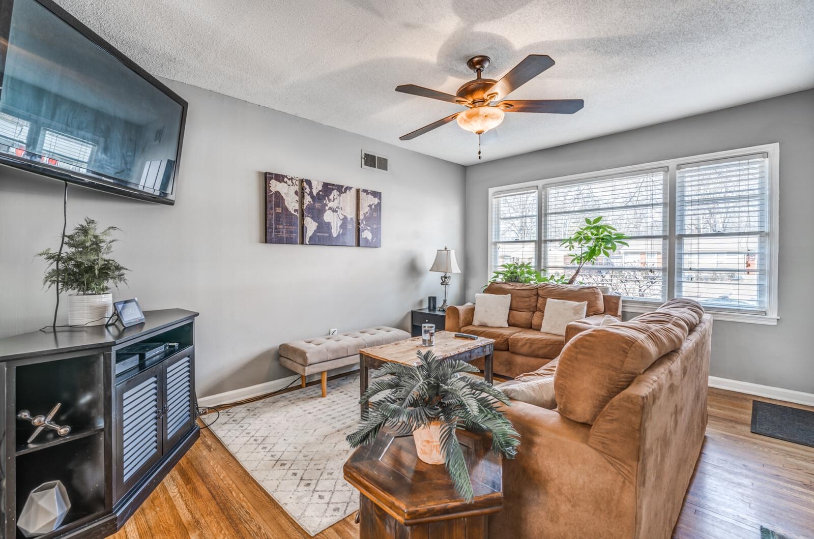 1450 Walton Road Memphis, TN 38117 - Photo 7 of 25 a living room with furniture a chandelier and a window