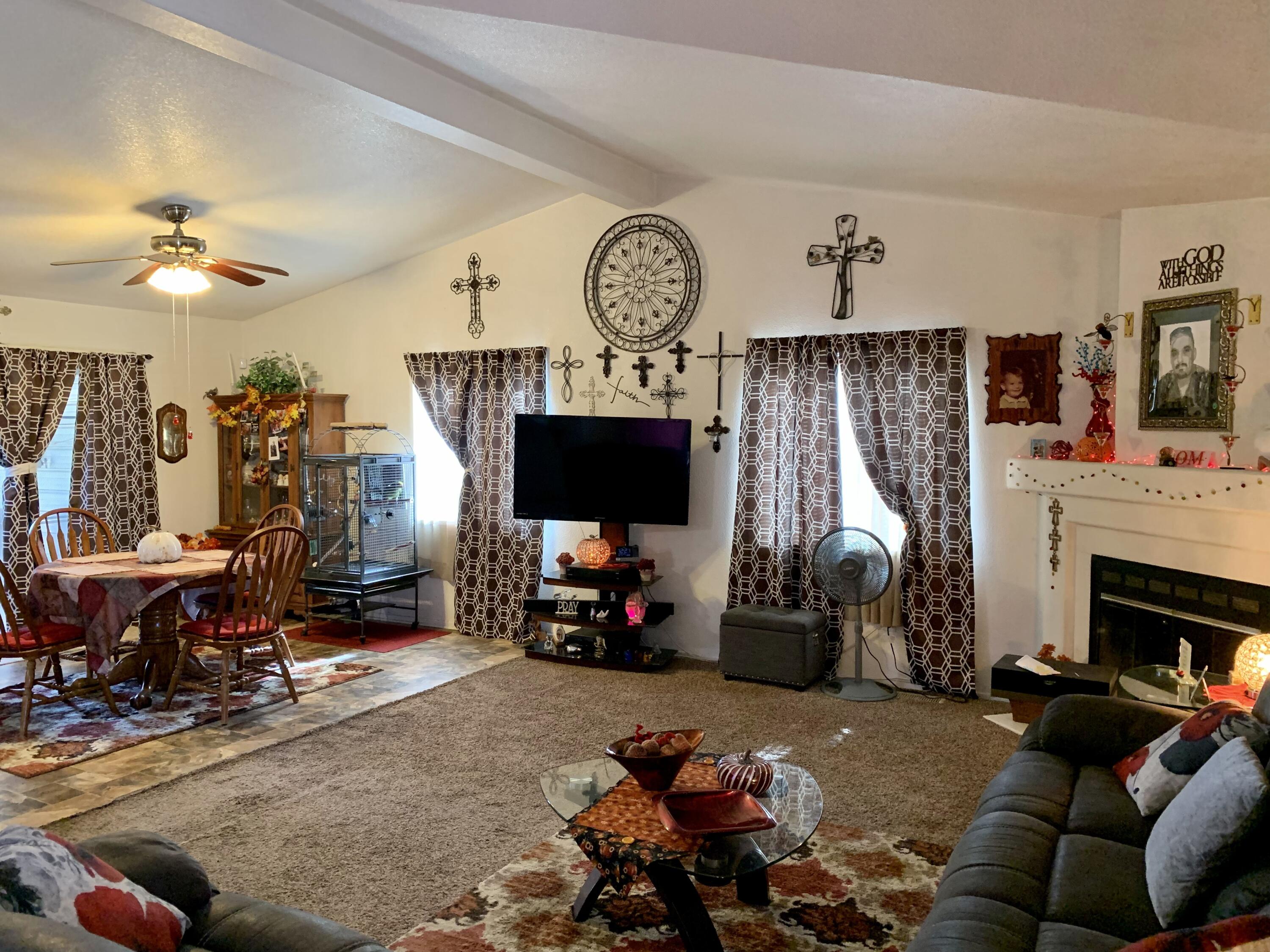 13310 Joshua Road Whitewater, CA 92282 - Photo 2 of 26 a living room with furniture a flat screen tv and a fireplace