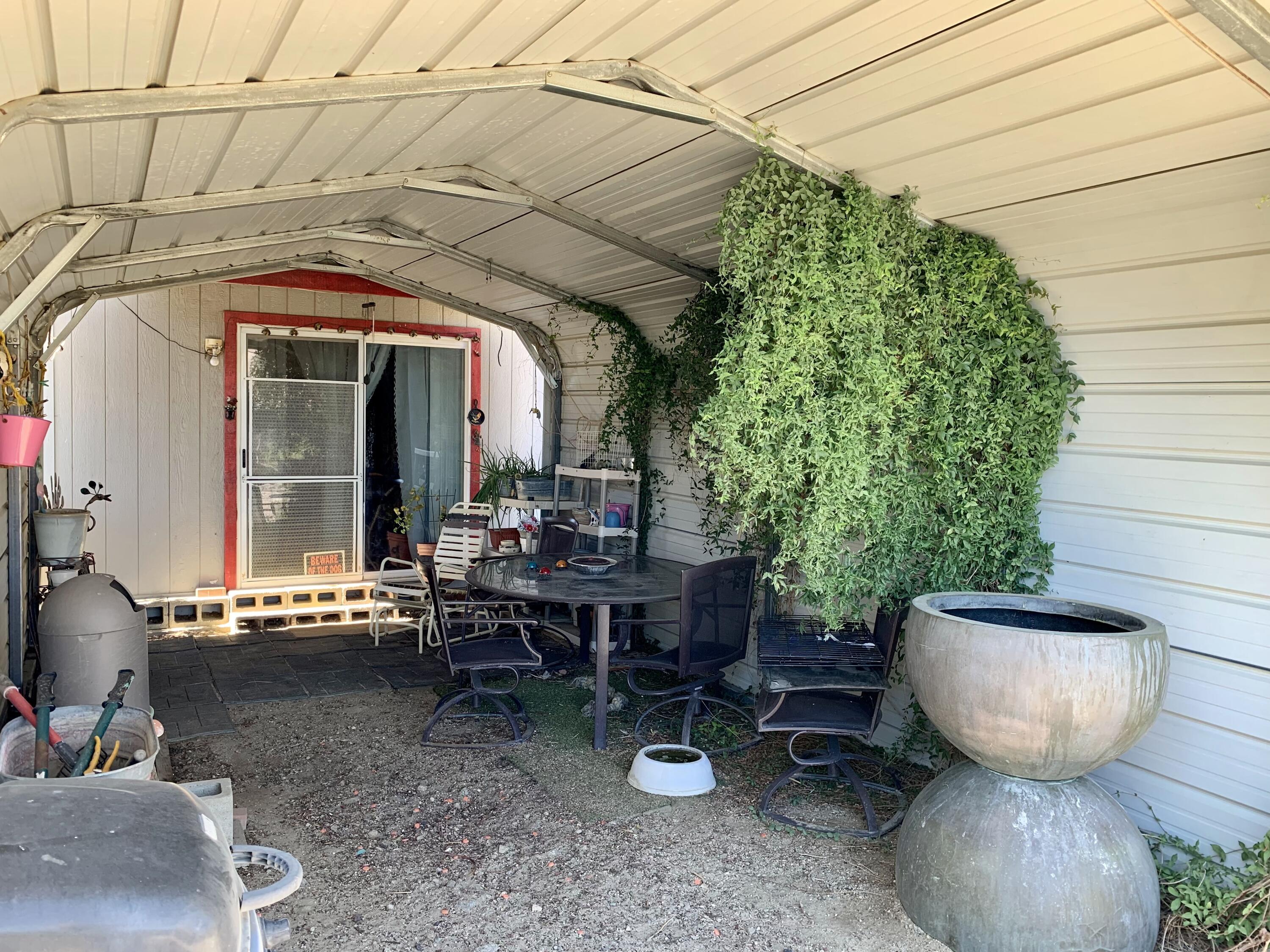 13310 Joshua Road Whitewater, CA 92282 - Photo 18 of 26 a view of a patio with table and chairs potted plants