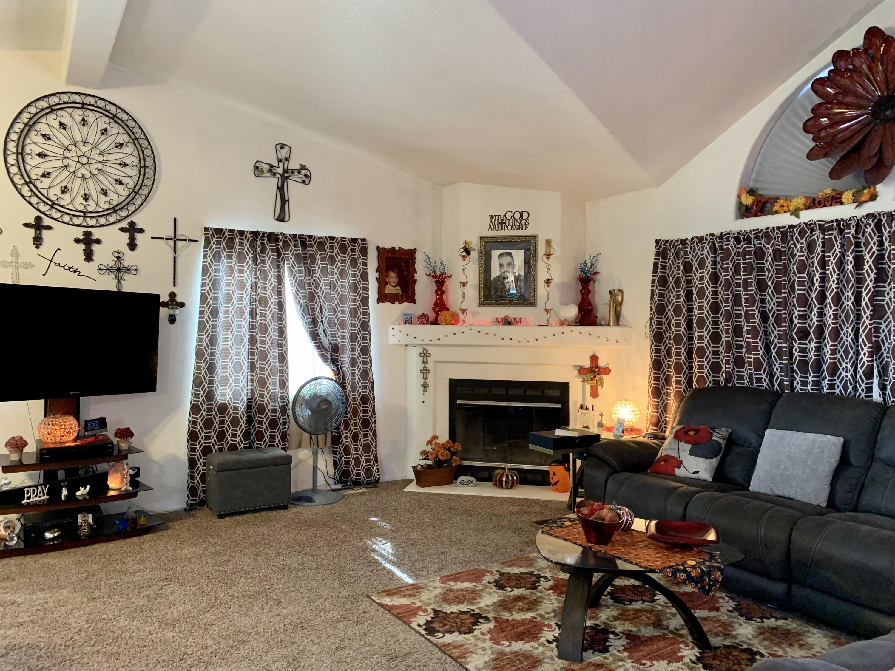 13310 Joshua Road Whitewater, CA 92282 - Photo 4 of 26 a living room with furniture a flat screen tv and a fireplace