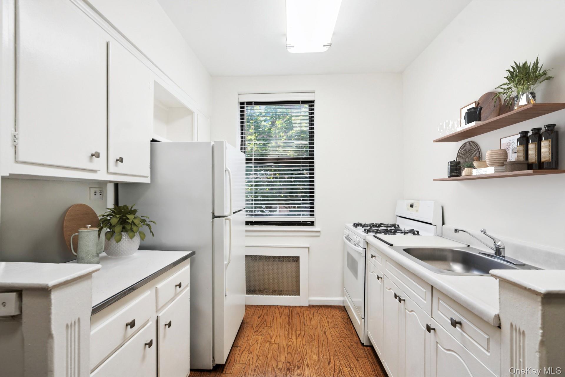90 Schenck Avenue, Unit 2L Great Neck, NY 11021 - Photo 7 of 11 a kitchen with a sink stove and cabinets