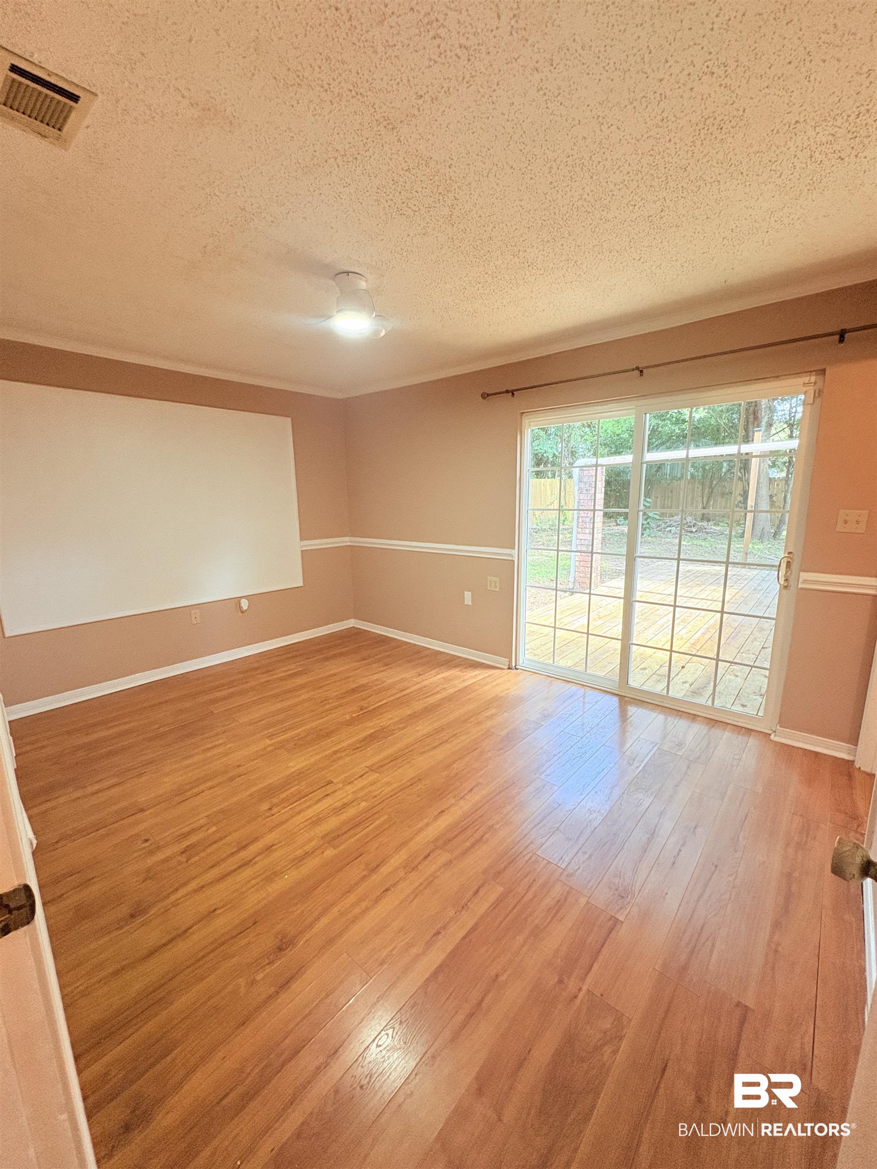 8070 Middle Ring Road Mobile, AL 36619 - Photo 16 of 26 Empty room with a textured ceiling and light wood-style floors