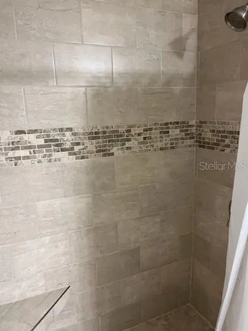 a bedroom with a bed and a television