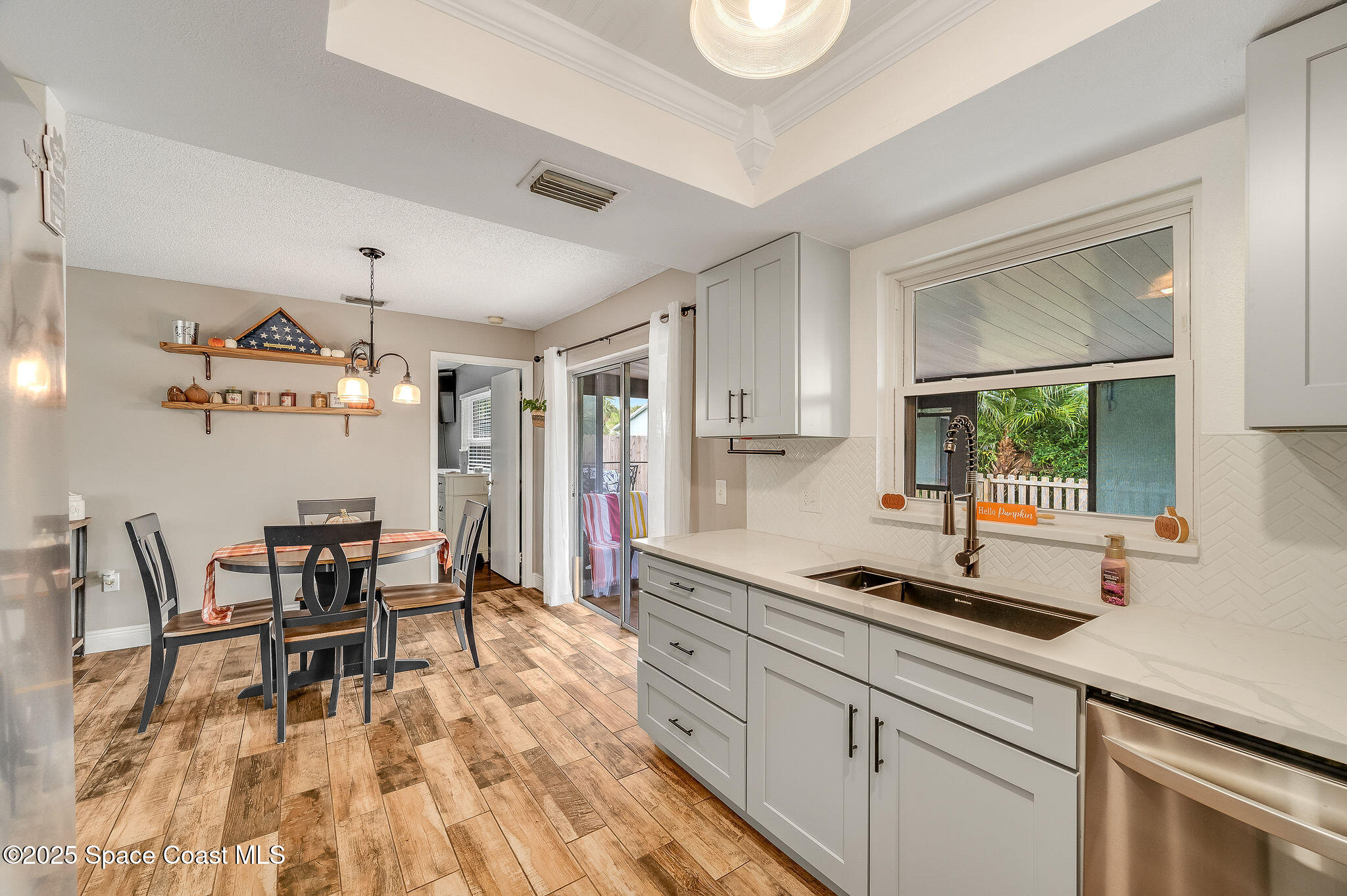 3816 Parapet Drive Cocoa, FL 32926 - Photo 12 of 32 a kitchen with a dining table chairs and large window