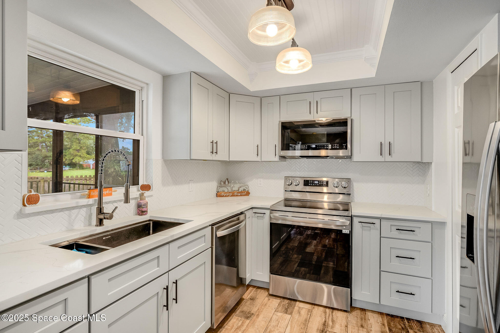 3816 Parapet Drive Cocoa, FL 32926 - Photo 13 of 32 a kitchen with stainless steel appliances a stove a sink and a microwave