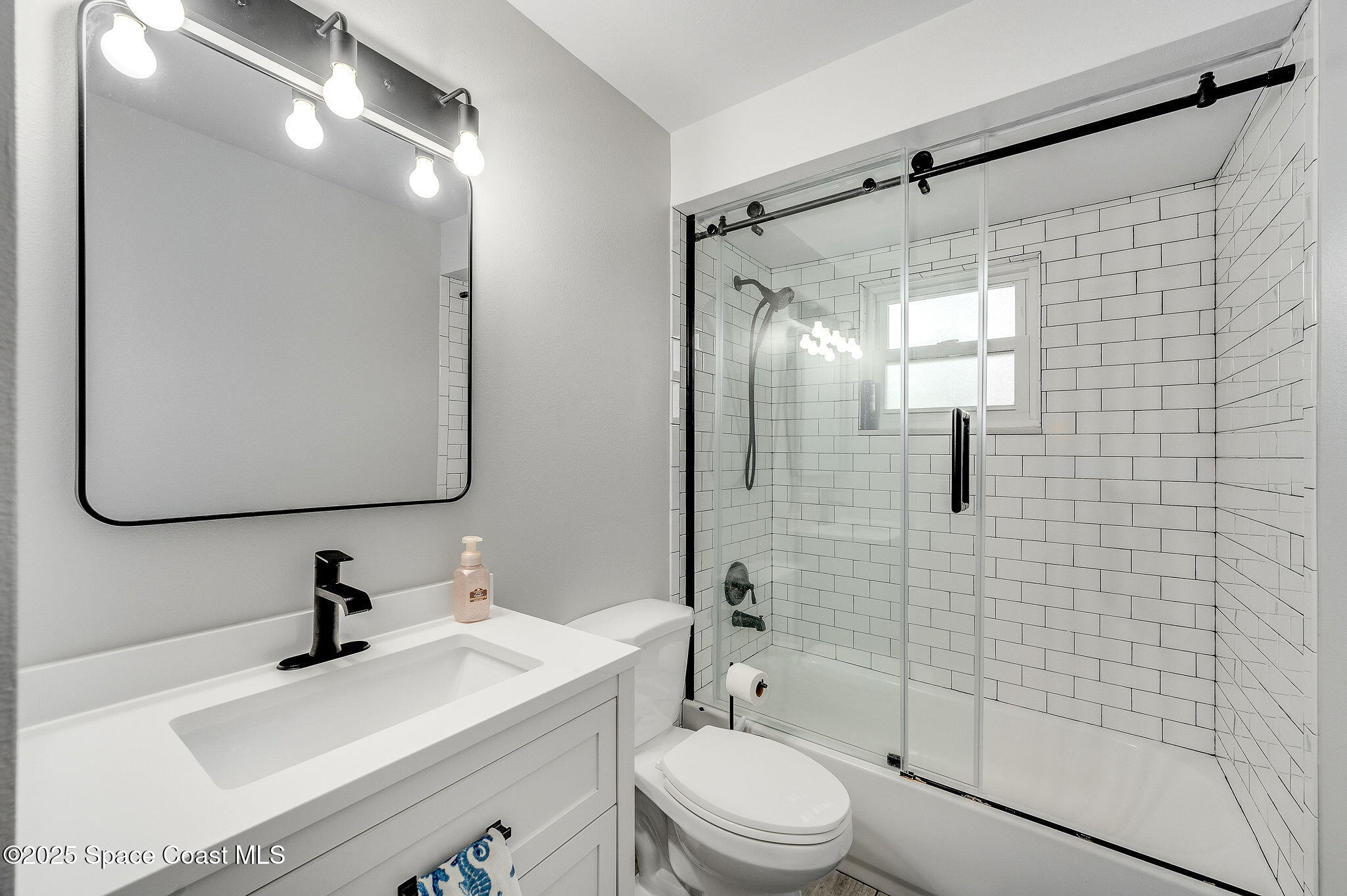3816 Parapet Drive Cocoa, FL 32926 - Photo 15 of 32 a bathroom with a sink mirror toilet and shower