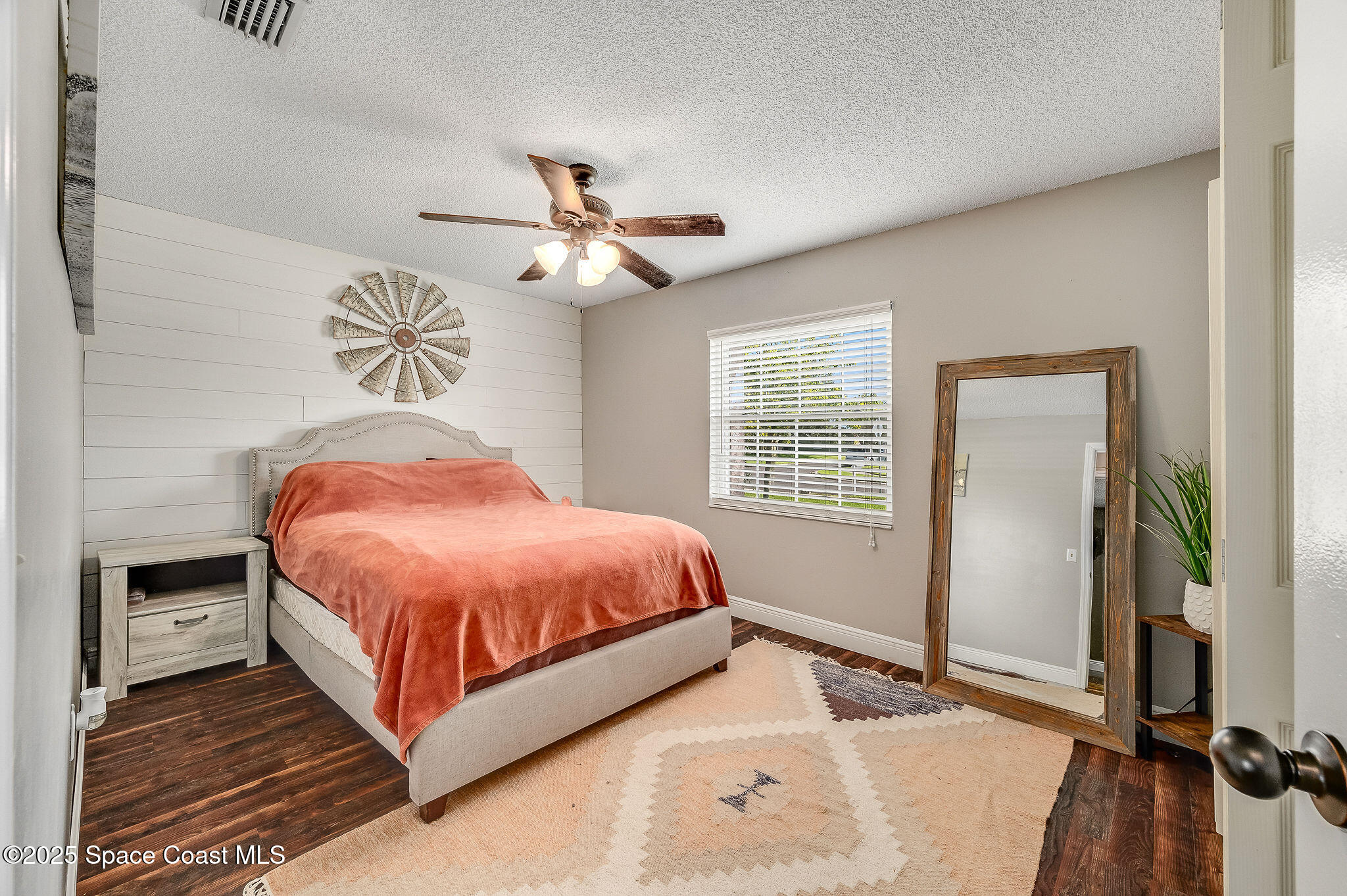 3816 Parapet Drive Cocoa, FL 32926 - Photo 16 of 32 a spacious bedroom with a bed and a chandelier
