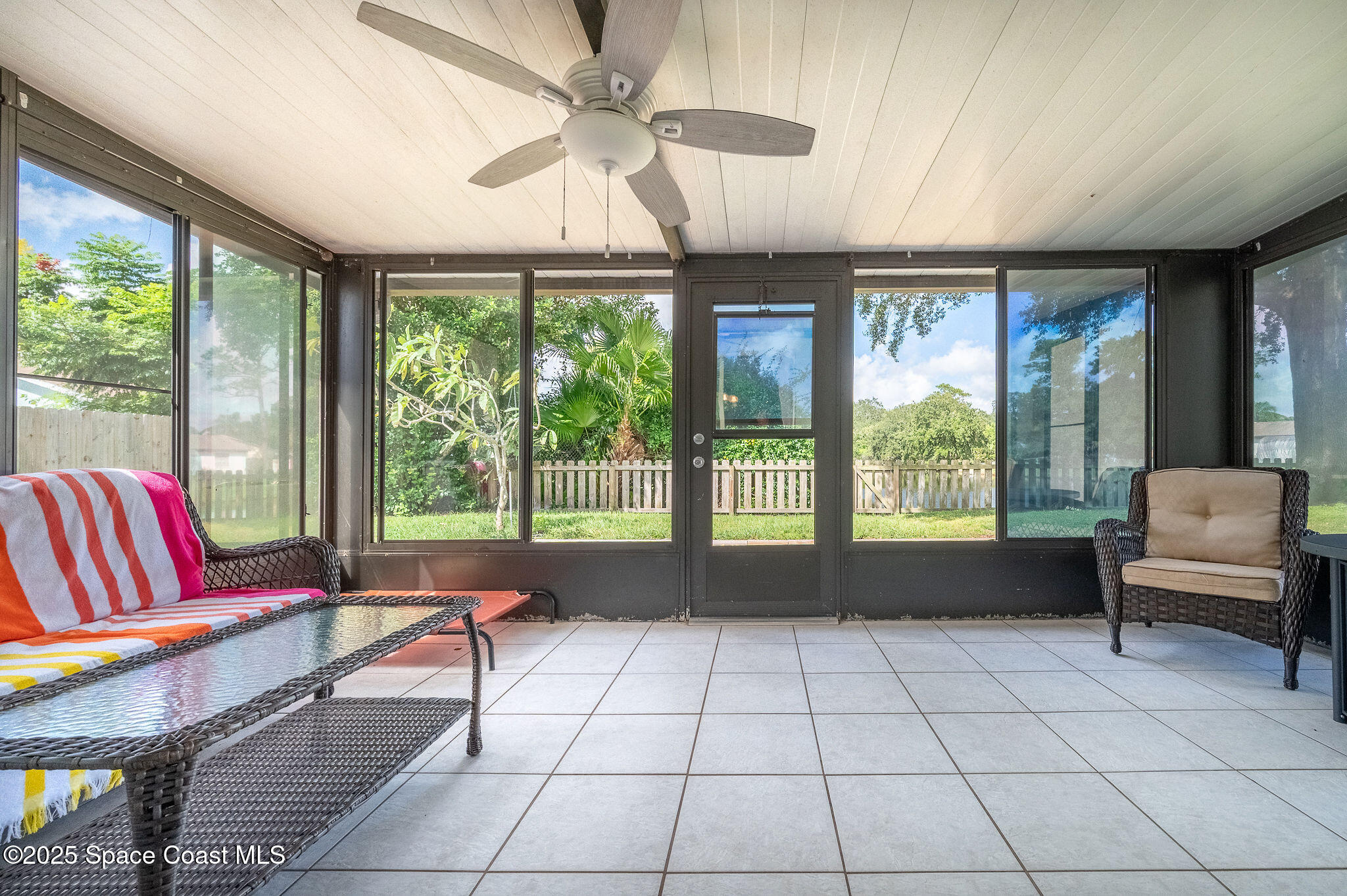 3816 Parapet Drive Cocoa, FL 32926 - Photo 24 of 32 a living room with furniture and a floor to ceiling window