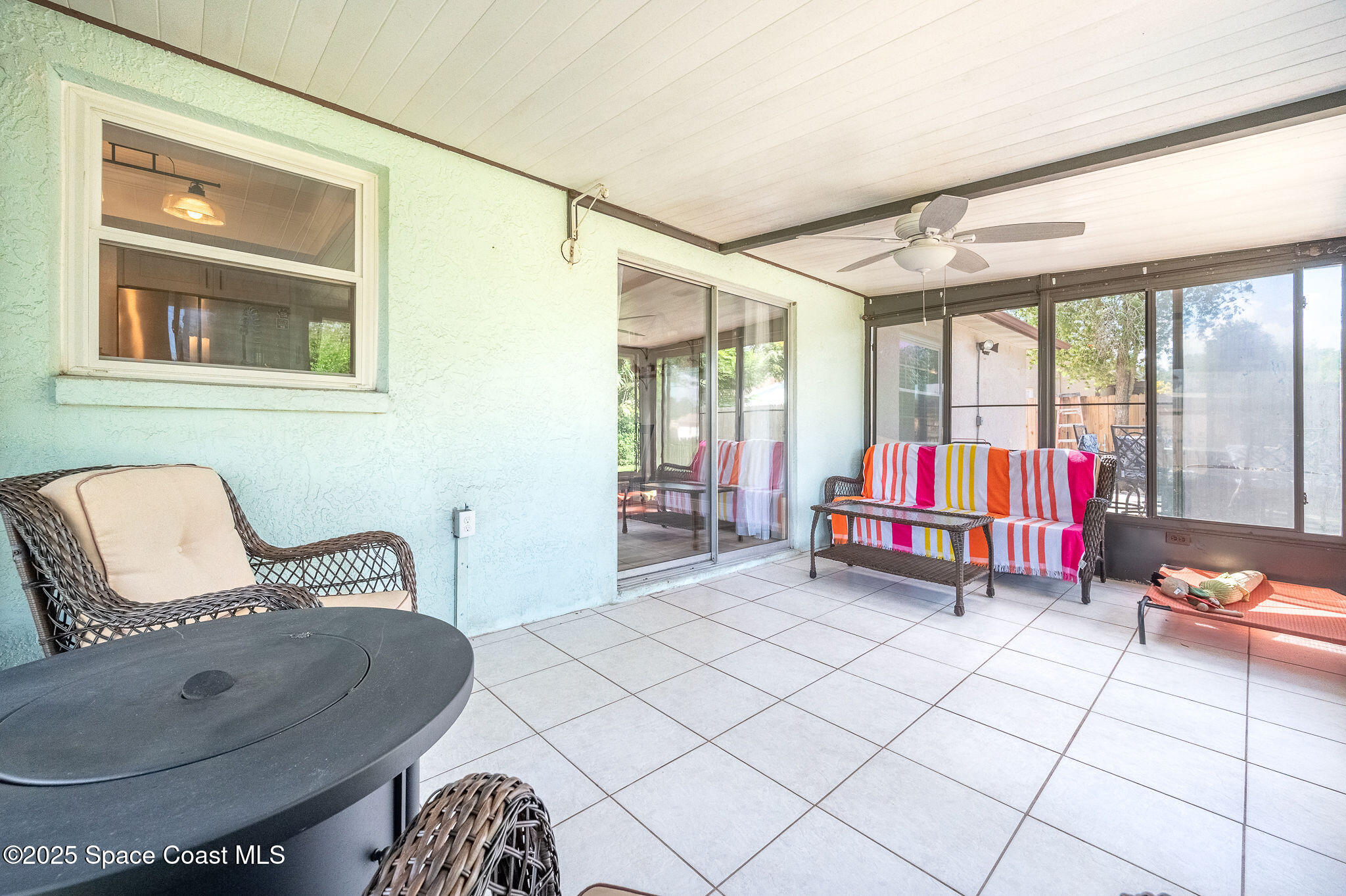 3816 Parapet Drive Cocoa, FL 32926 - Photo 26 of 32 a living room with furniture and a floor to ceiling window