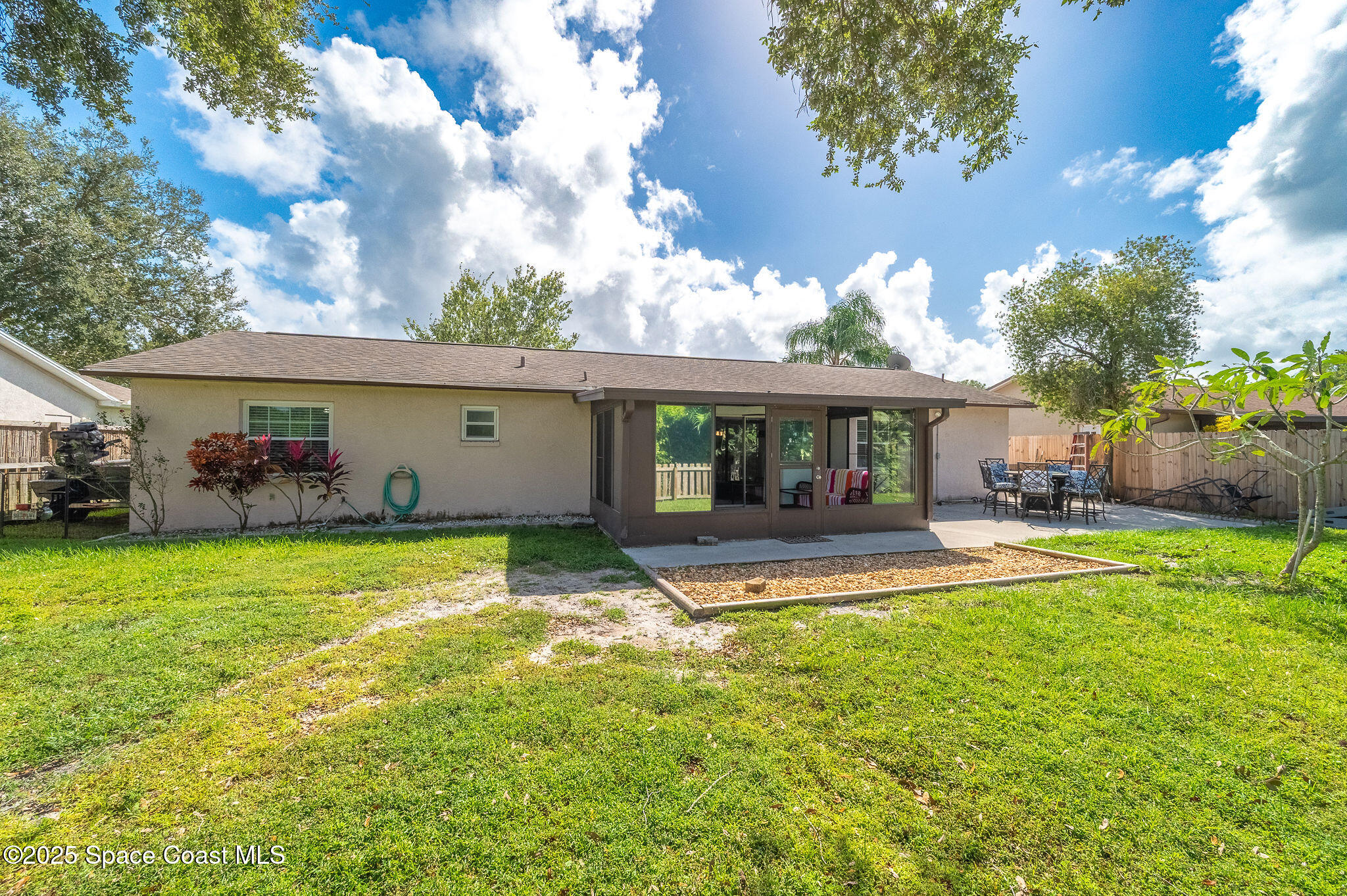 3816 Parapet Drive Cocoa, FL 32926 - Photo 31 of 32 a front view of house with a garden and tree