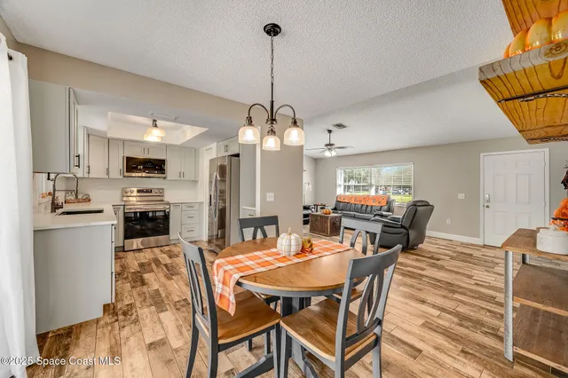 a kitchen with stainless steel appliances a stove refrigerator and microwave