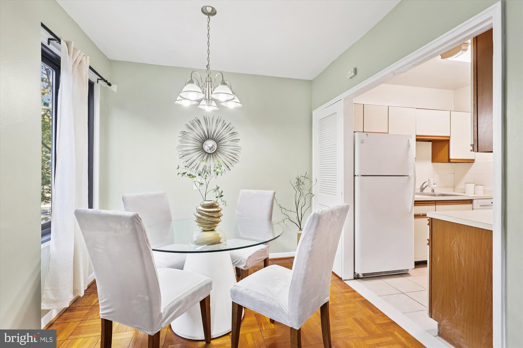 3601 Wisconsin Avenue Northwest, Unit 111 Washington, DC 20016 - Photo 2 of 21 a dining room with furniture a chandelier and wooden floor