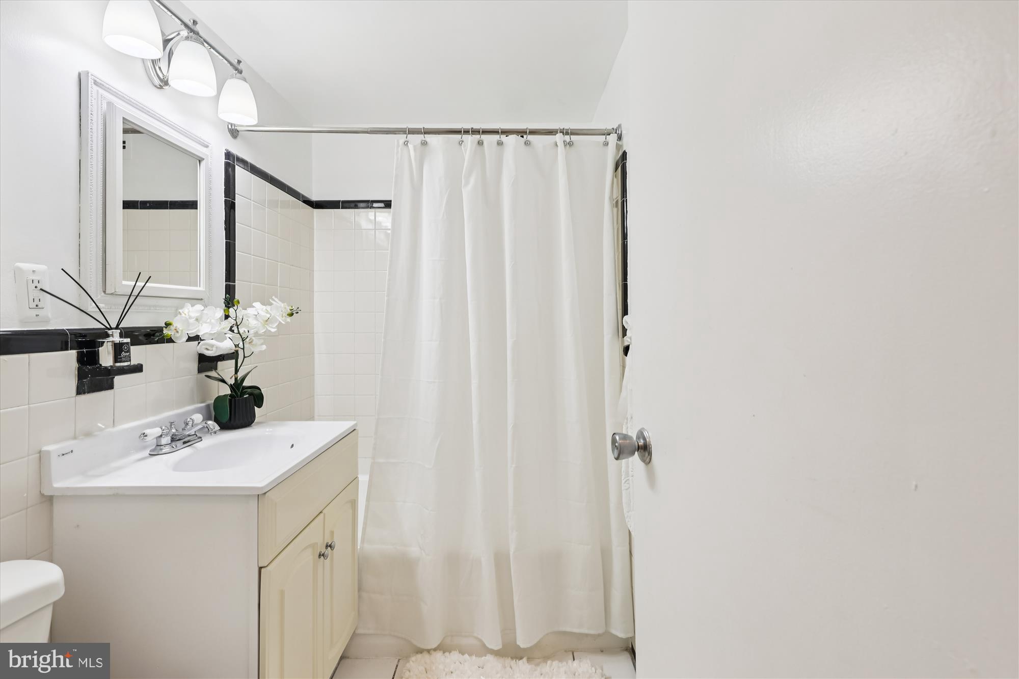 3601 Wisconsin Avenue Northwest, Unit 111 Washington, DC 20016 - Photo 5 of 21 a bathroom with a sink a mirror and a shower