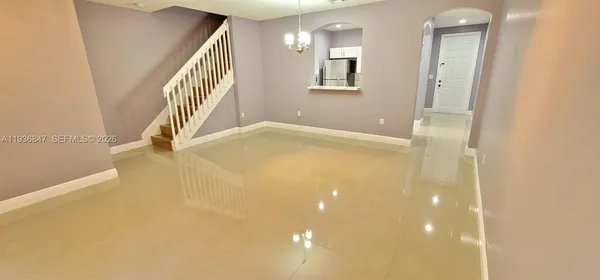 a view of empty room with stairs