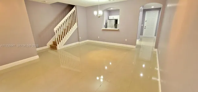 a view of empty room with stairs