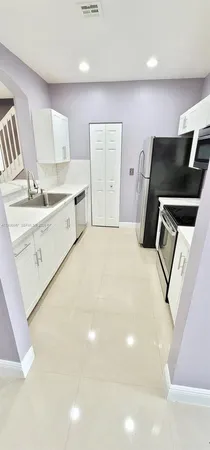 a bedroom with a bed and a television