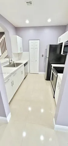 a bedroom with a bed and a television