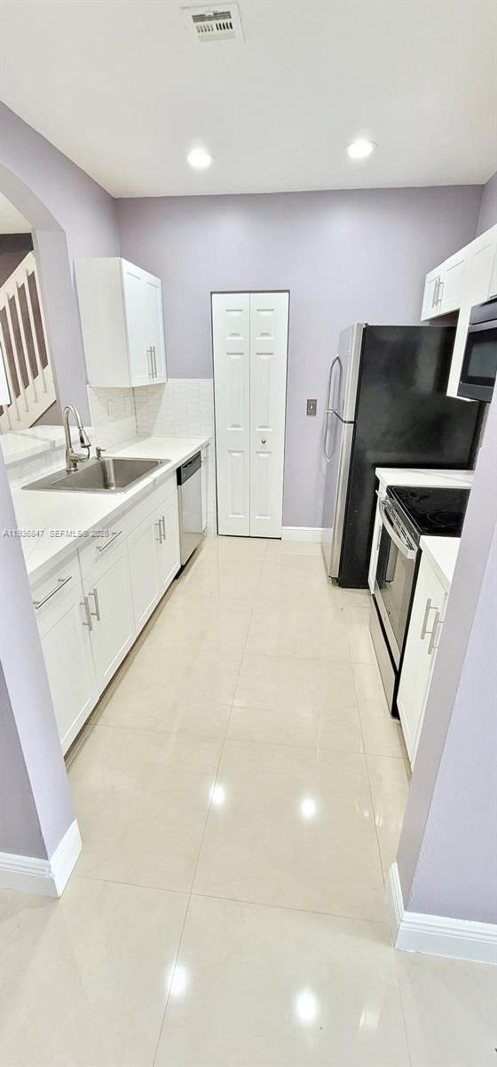 1005 Northeast 42nd Place Homestead, FL 33033 - Photo 6 of 20 a bedroom with a bed and a television