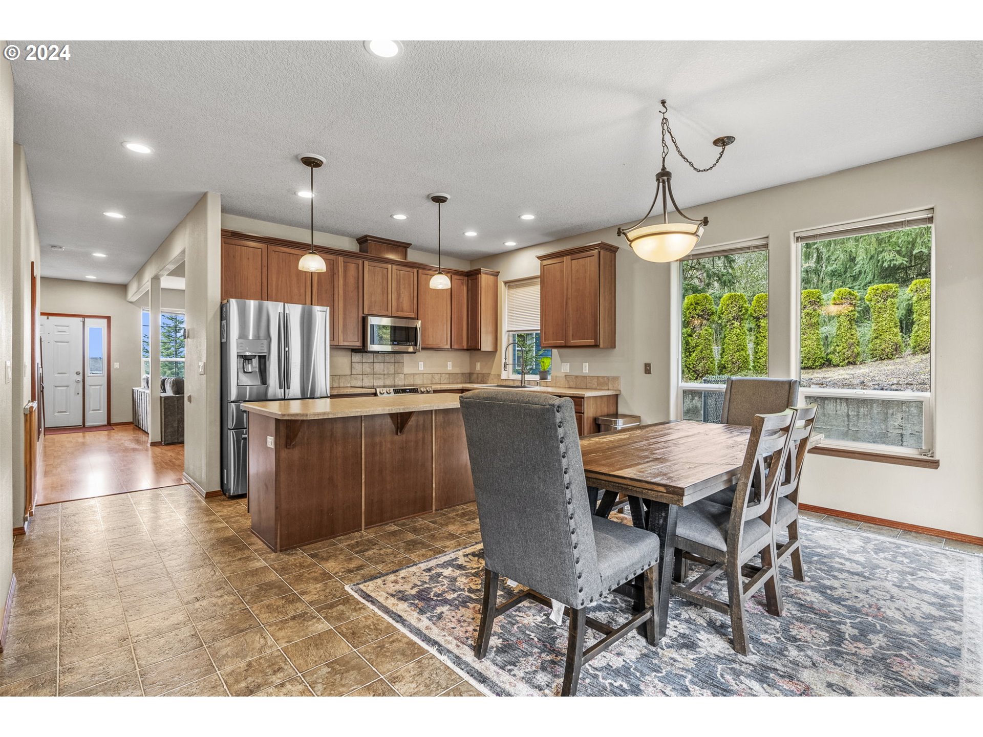 145 Ruby Court Kelso, WA 98626 - Photo 11 of 35 a dining hall with stainless steel appliances a dining table wooden floor a rug and a window